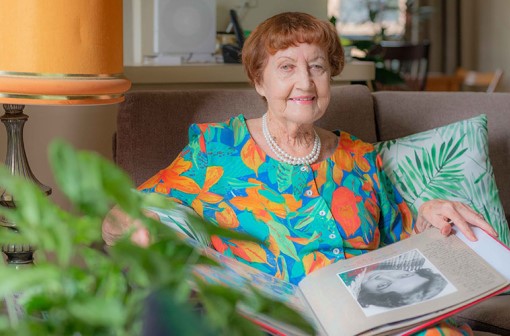 Joan Dalgleish at home with a photo album of her life as a performing artist