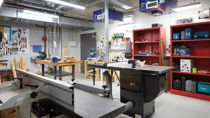 Shared workshop space filled with tools and work benches