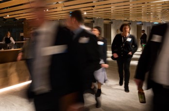 photo of business people walking through lobby of building