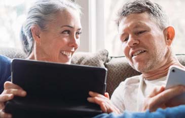 Couple smiling at iPad