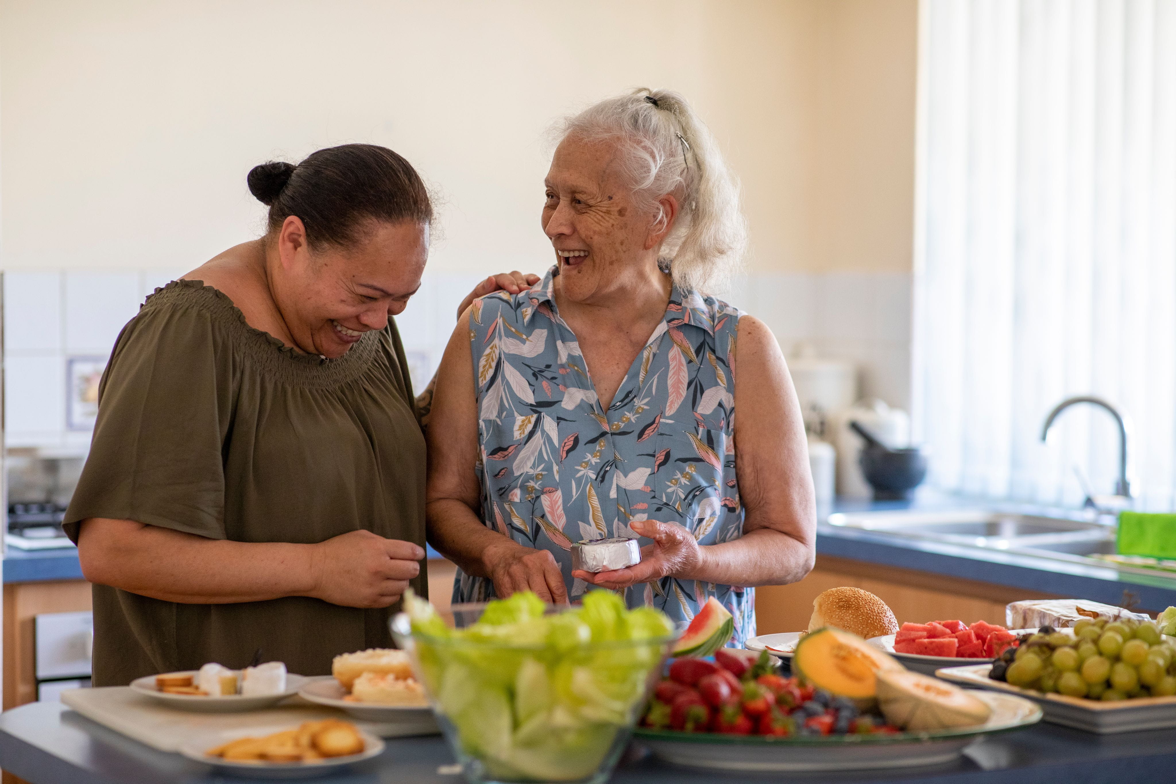 Aboriginal carer and elder laughing together