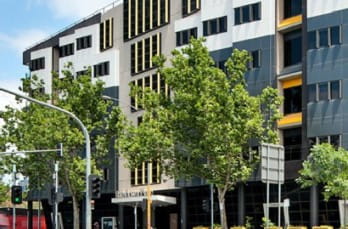 Photo of exterior of modern building with trees in front