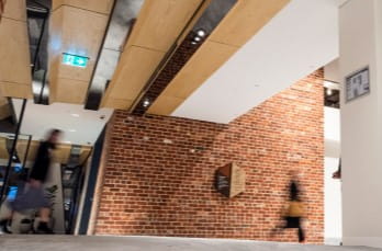 Photo of people walking through a building lobby