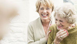 Image of two old ladies laughing together.