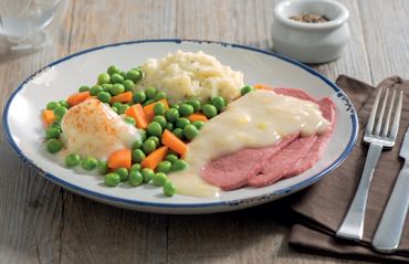 Plate of peas, carrots, mashed potatoes and beef.