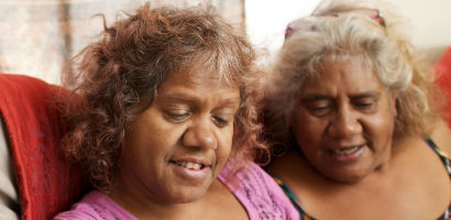 Two Aboriginal women looking at a tablet