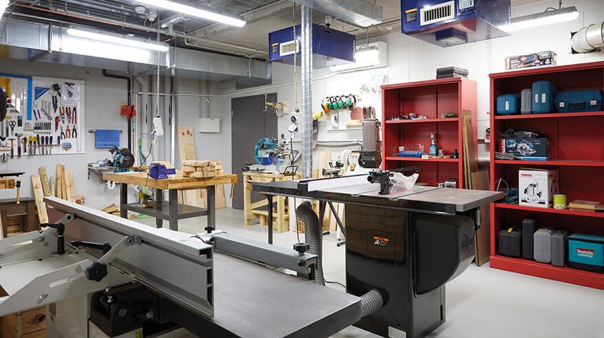Shared workshop space filled with tools and work benches