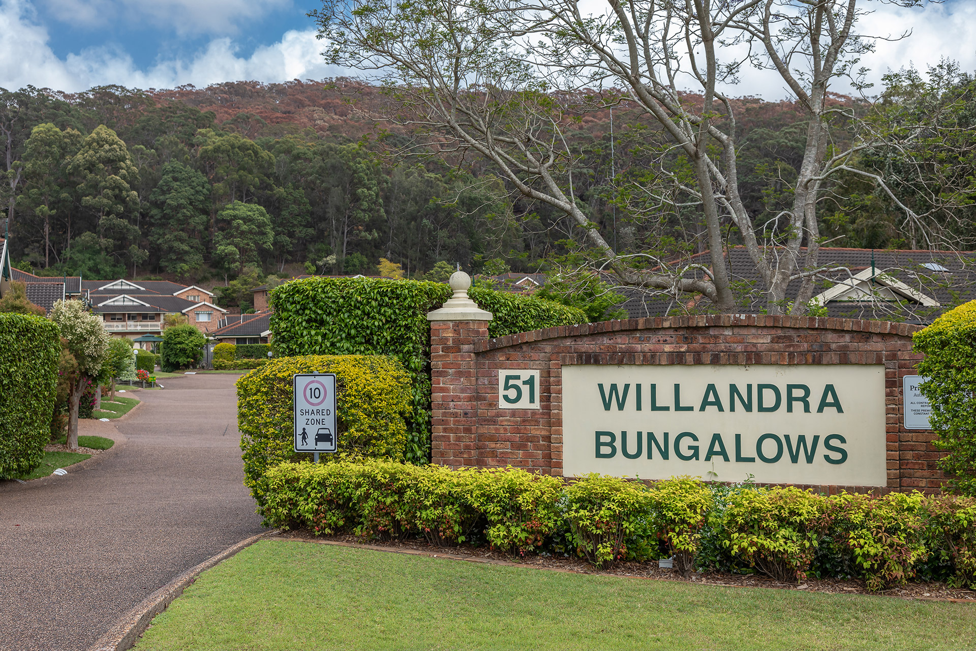 Willandra Bungalows entrance surrounded by well pruned hedges