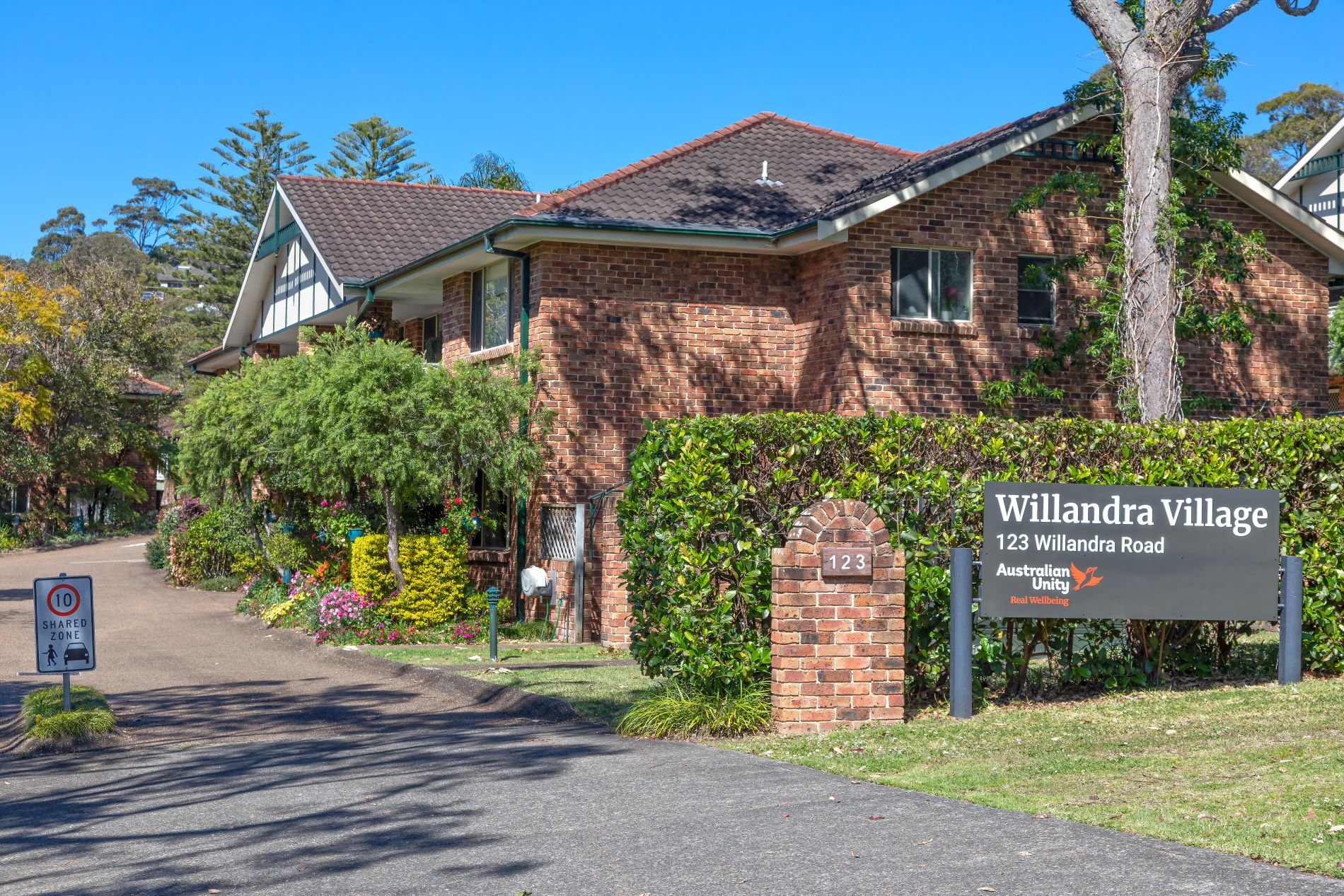 Willandra village entrance, with pristine hedges and driveways