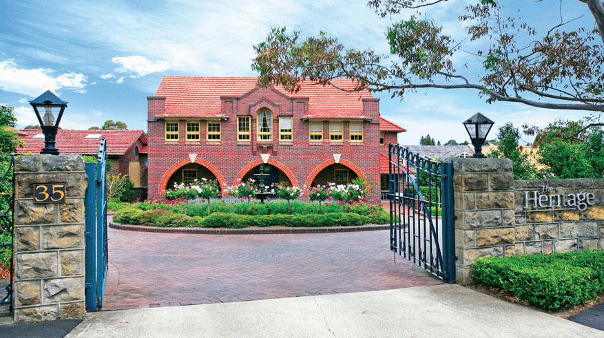Front landscape of The Heritage of Hunters Hill. Red brick building.