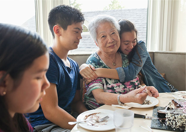 Grandma surrounded by her grandchildren at the dining table