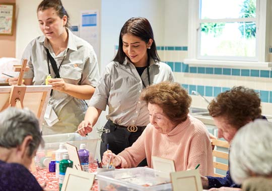 Elderly woman and grand daughter using a laptop together