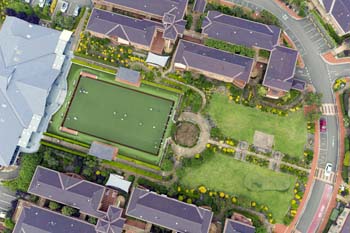 Birdseye view of lush bowls court and garden