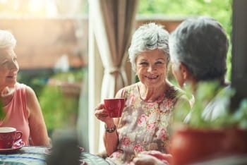 Photo of elderly friends enjoying tea