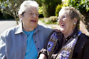A pair of retired friends laughing together