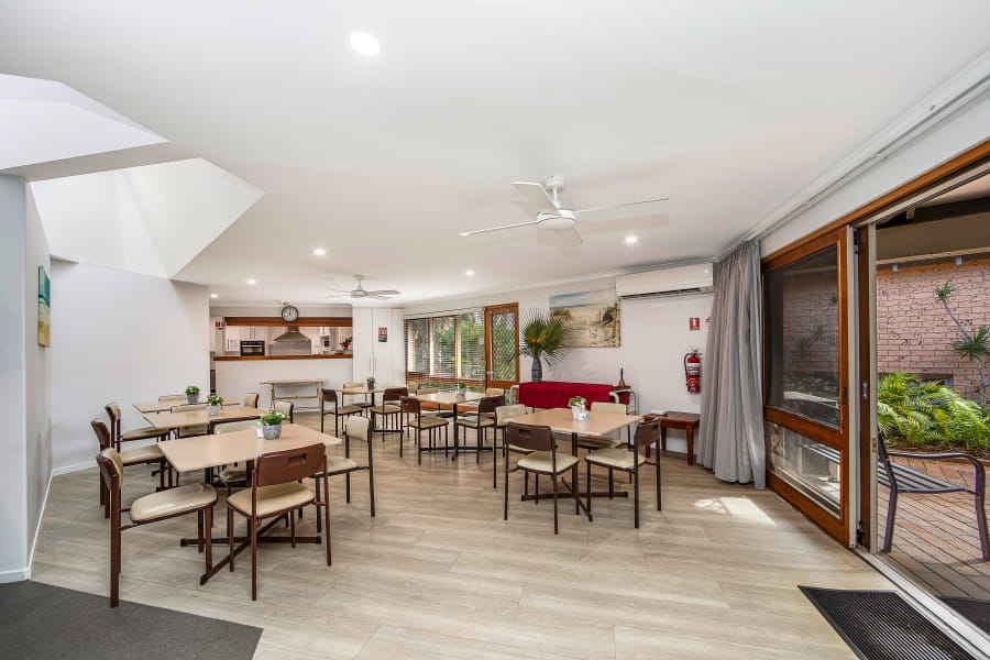 A modern indoor eating area that opens to the outdoors