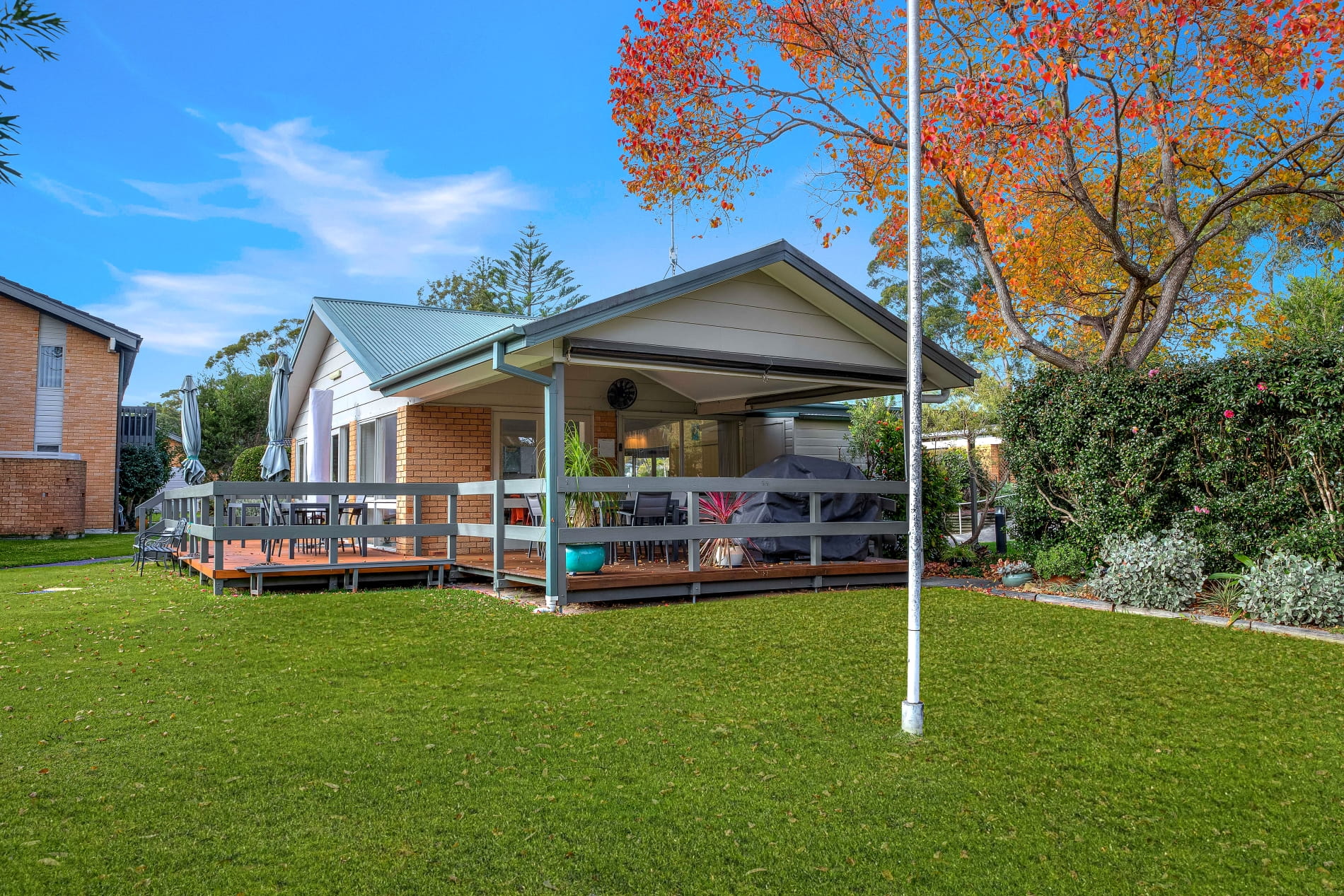 Karagi cabin surrounded by lush lawns and gardens