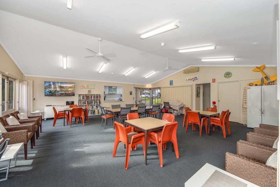 Indoor activities room with bookshelves, a hobby plane, and attached kitchenette
