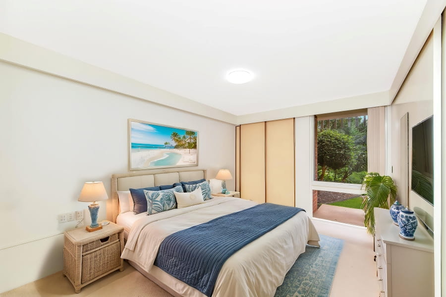 Modern bedroom with greenery out the window