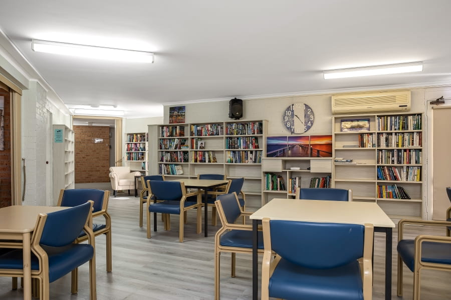 Activities room surrounded by bookshelves