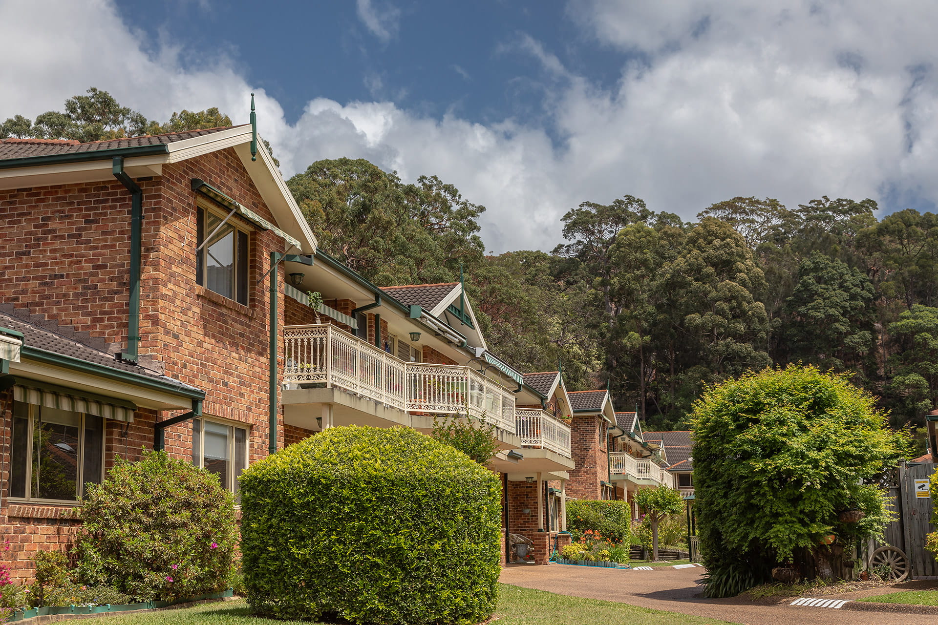 Brick building framed by bushland
