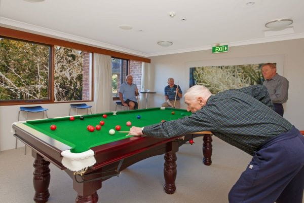Residents happily playing billiards against each other