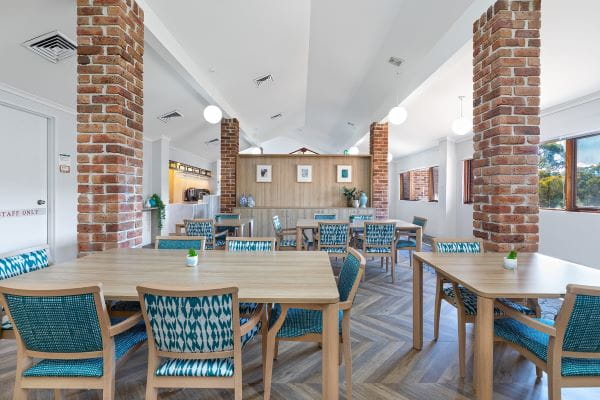 Dining area with brick columns and nature views