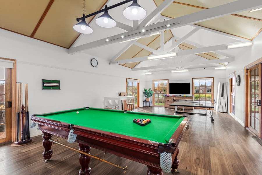 Billiards table in a modern well lit activities room