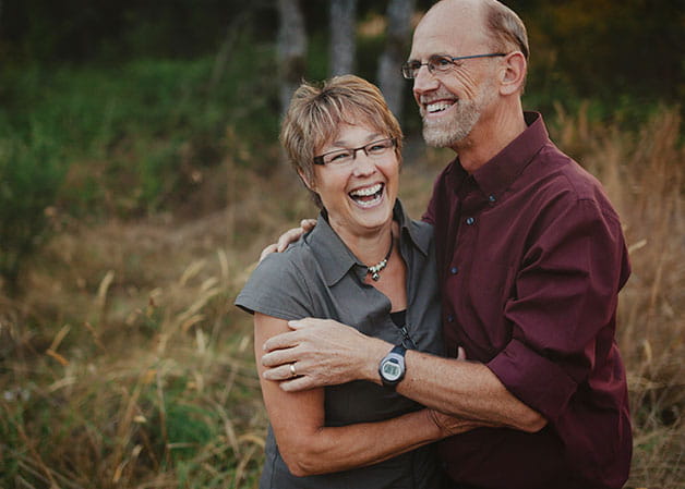 Woman and man hugging and laughing