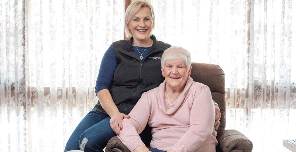 Care worker and client smiling