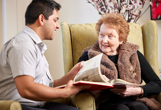 Carer reading to a resident