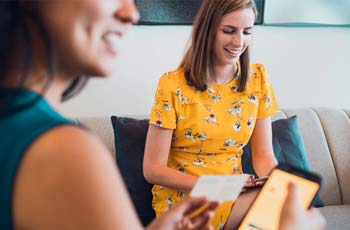 photo of two women using laptops