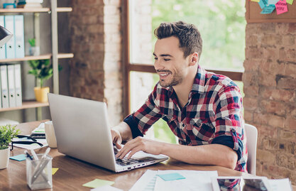 photo of a man using a laptop