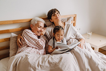 Lesbian couple reading with their daughter