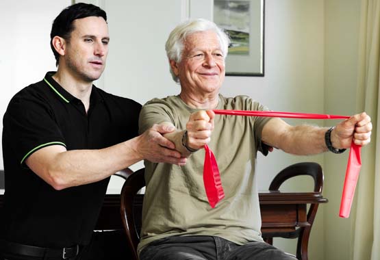 Man doing exercises with a physio therapist