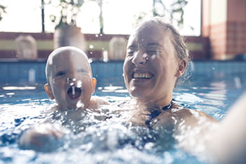 mum and baby swimming in pool