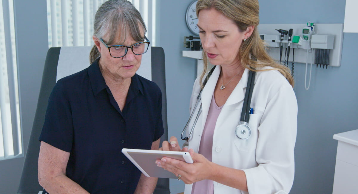 An older woman being shown a care plan by her health practitioner