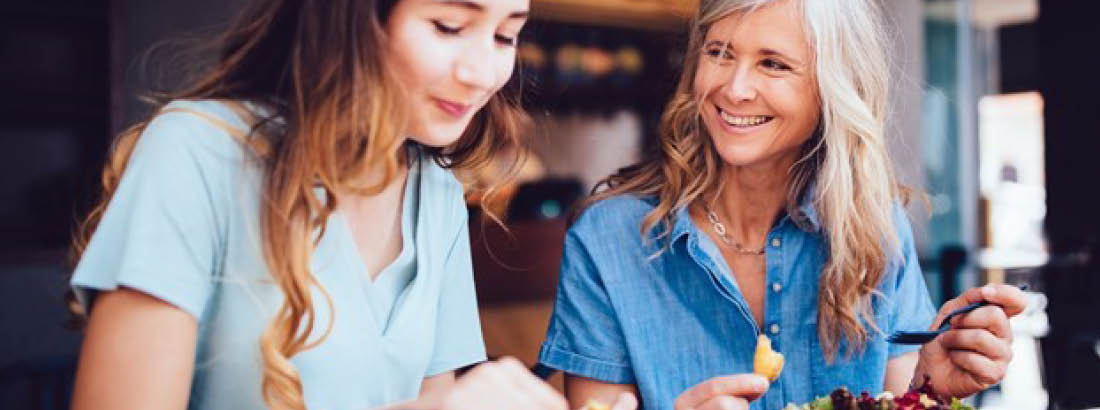 A young woman and an older woman enjoying lunch together