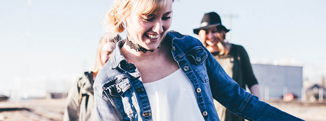 A young woman walking and having fund with her friends