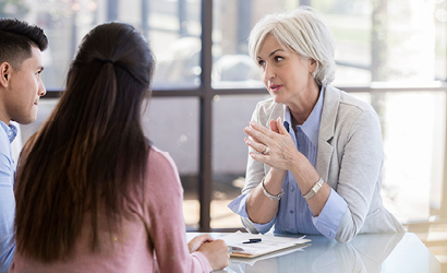 Woman sitting with clients providing advice