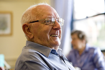 Old man with glasses smiling