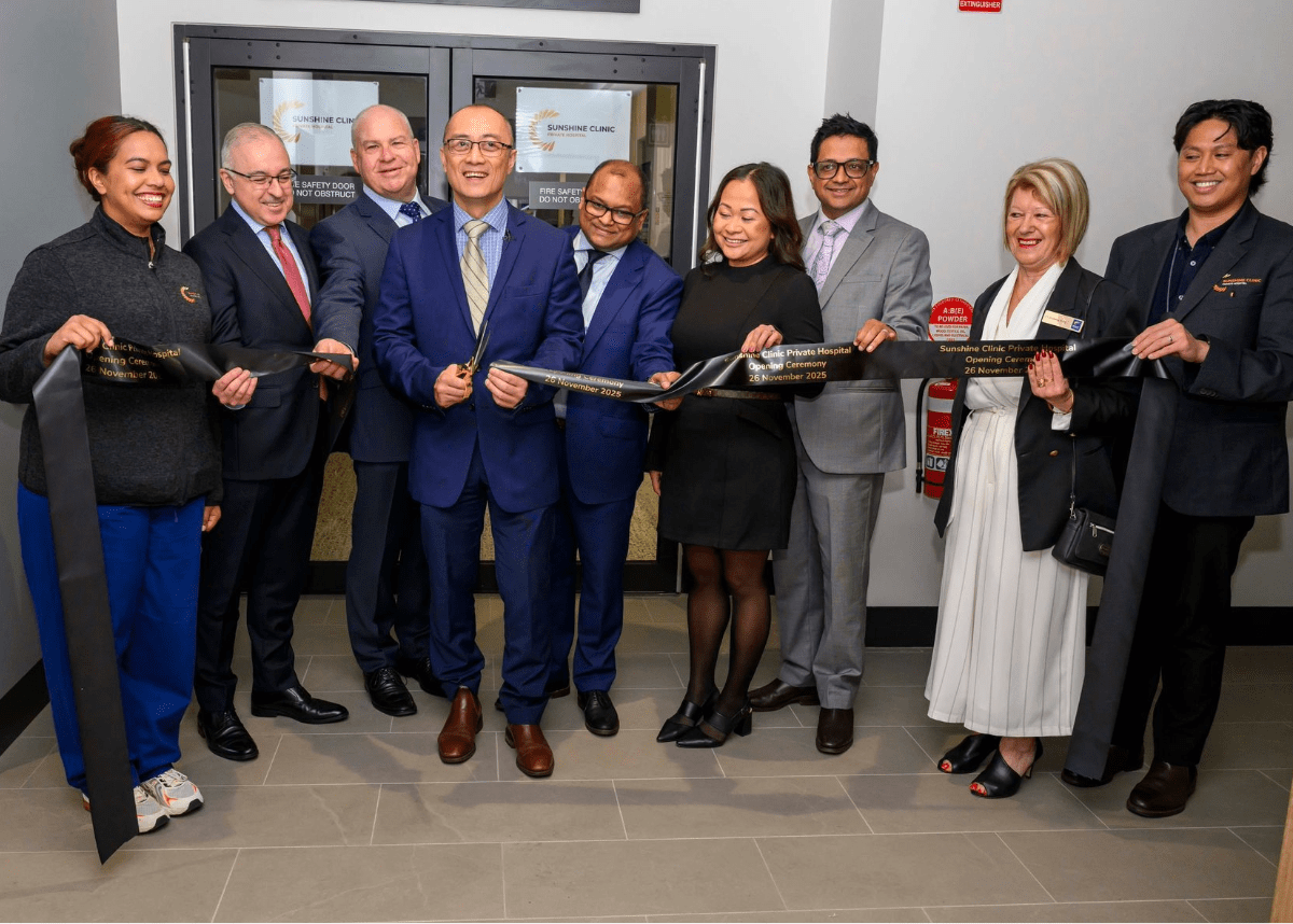 Formally dressed people cutting the ribbon for Sunshine clinic private hospital