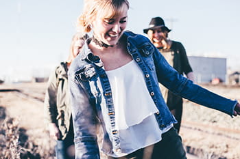 A young woman walking and having fund with her friends