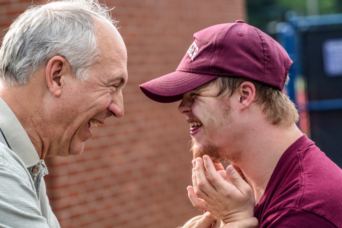 Older man laughing with younger man