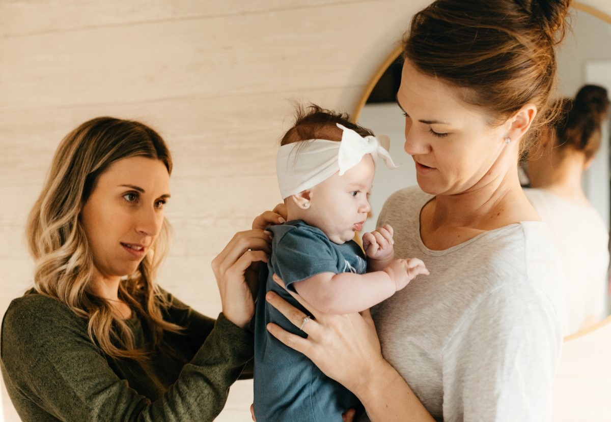 Two women looking after their baby