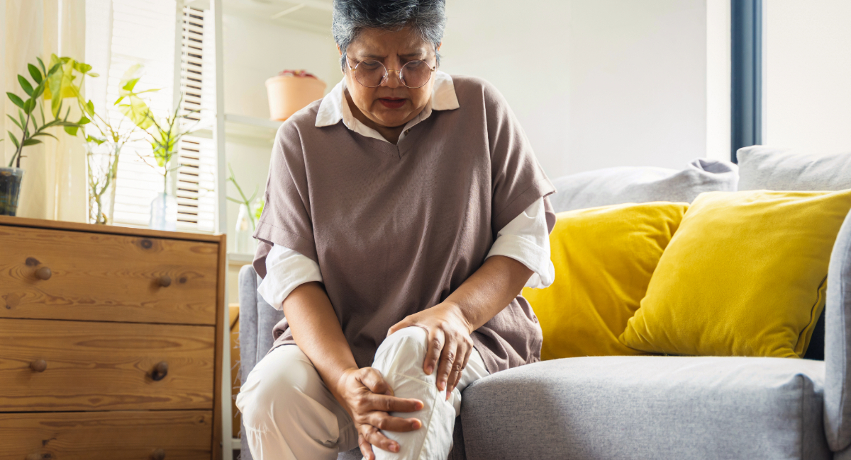 A woman in pain rubbing her knee