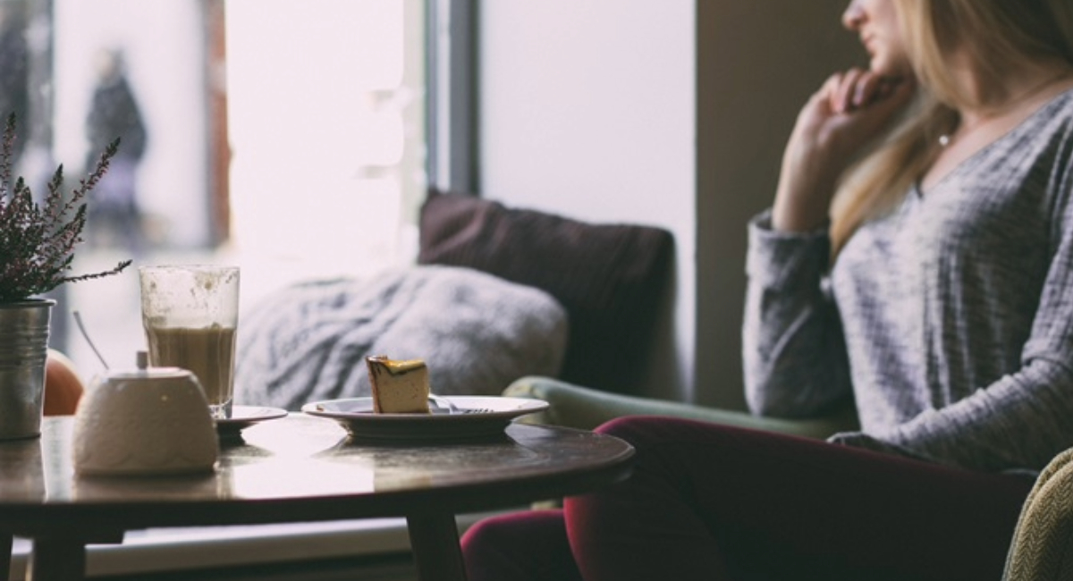 A woman sitting alone in a cafe
