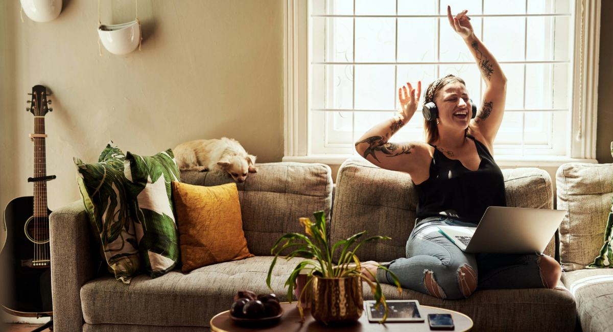 A woman on the couch listening to music