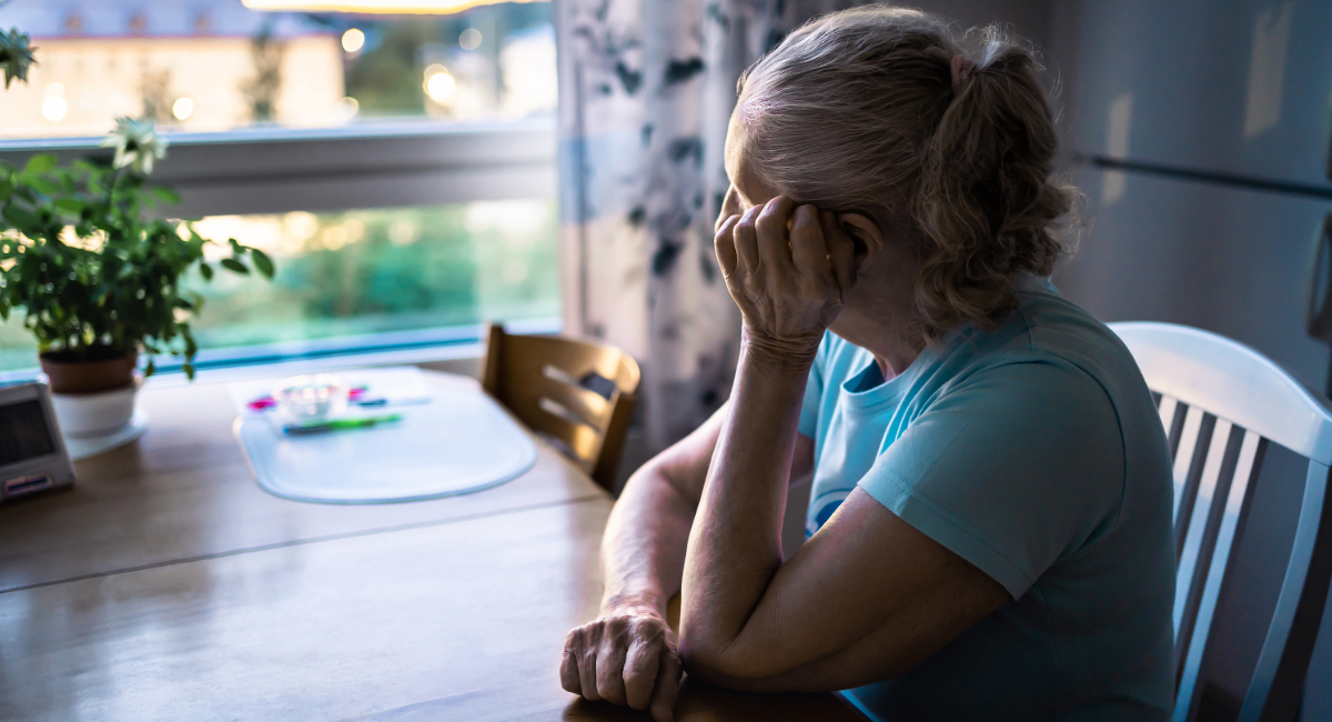 A depressed woman looking out a window