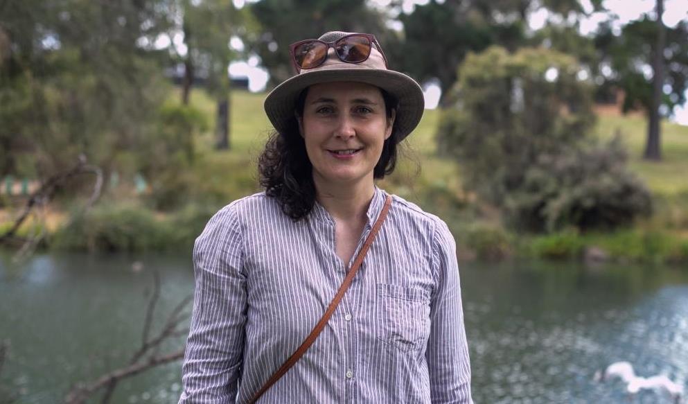 Marta Cifuentes standing in front of water and bushland